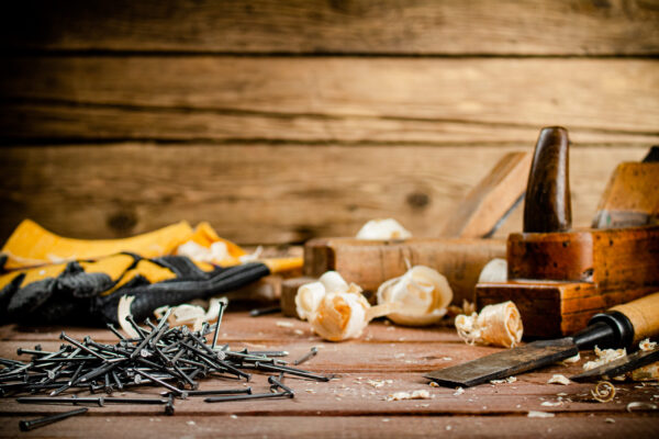A pile of nails on the table. On a wooden background. High quality photo