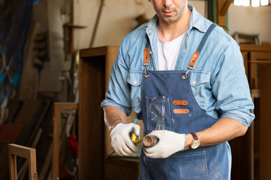 Carpenter working at his carpentry shop. Eyesight is utilized to ensure accuracy.