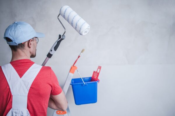 Interior Remodeling and Painting by Caucasian Remodeling and Construction Worker.
